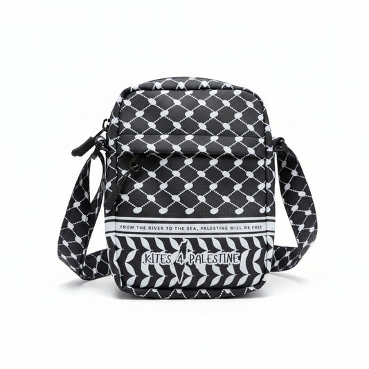 Gray and white patterned bag with 'Kites of Palestine' branding on a beige carpet.