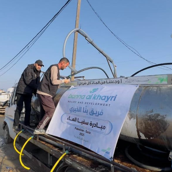 Two men working on a large cylindrical tank with a branded banner in the foreground.