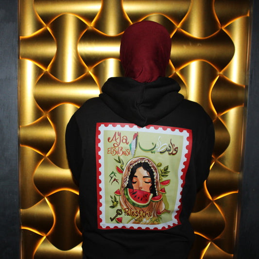 Person wearing a black hoodie with a colorful design on the back against a gold textured wall.