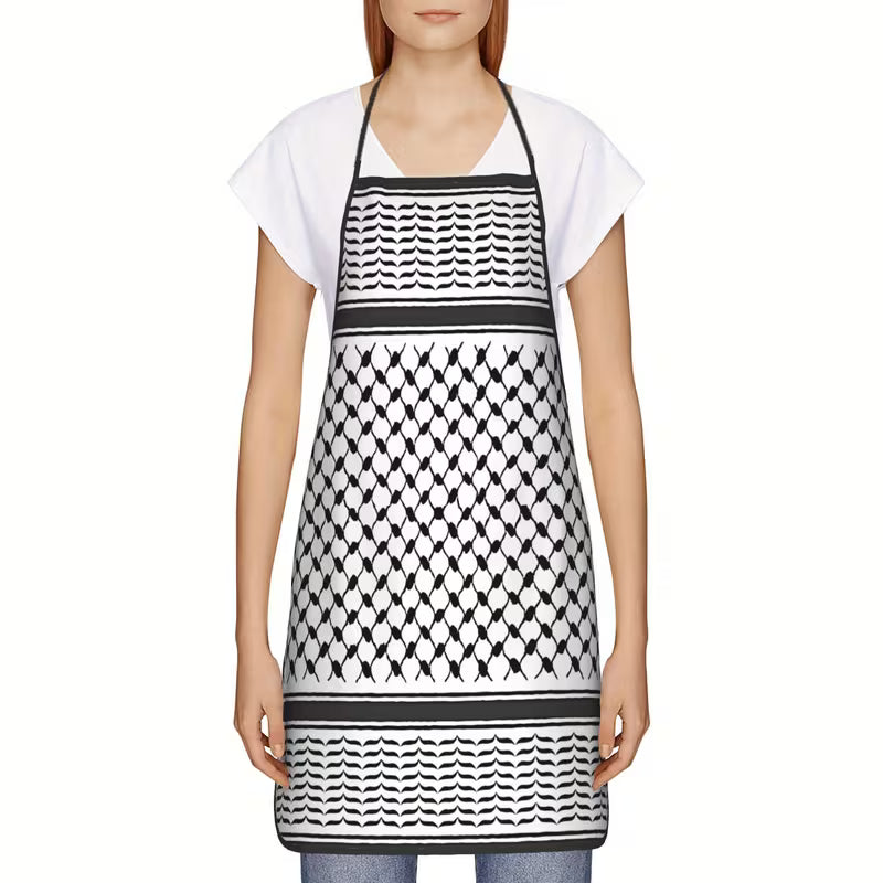 Person wearing a black and white patterned apron on a white background